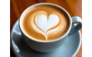 Secawan latte dengan seni latte berbentuk hati yang indah.